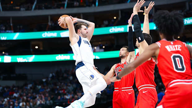 Dallas Mavericks superstar Luka Doncic takes flight as three Chicago Bulls look on.